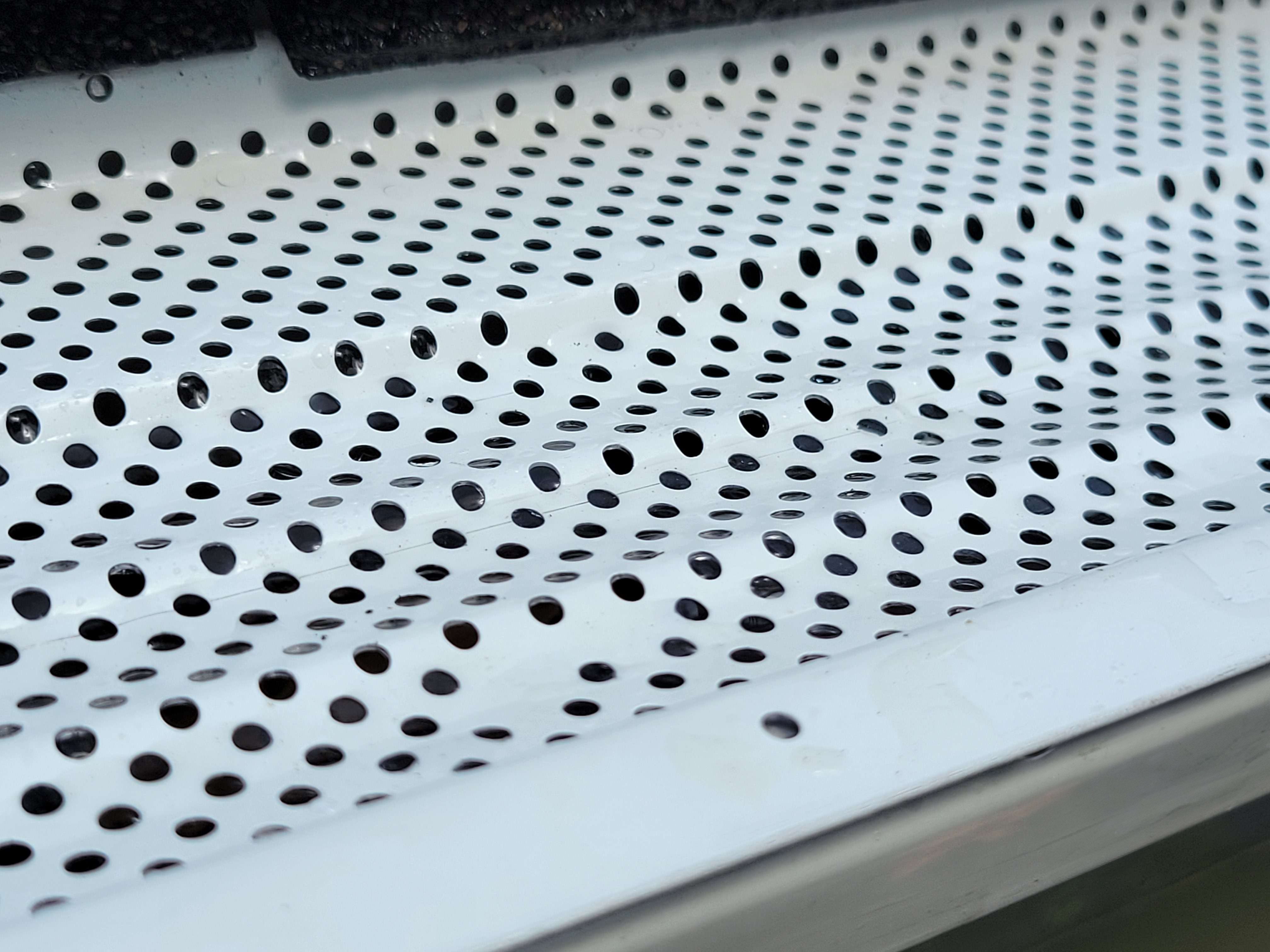 Close-up of Active Guard aluminum gutter protection showing corrosion-resistant material